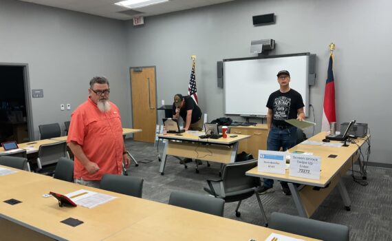 Amateur Radio Operators prparing a room for a test session.