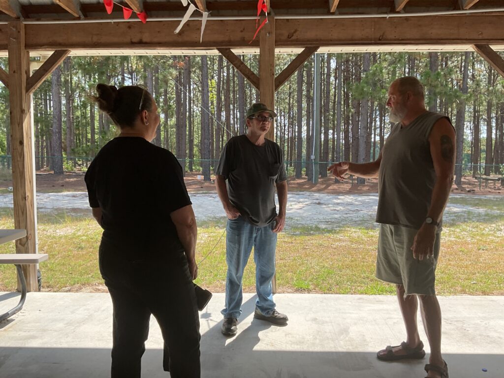 Amateur radio operators talking at club field day, 2024.