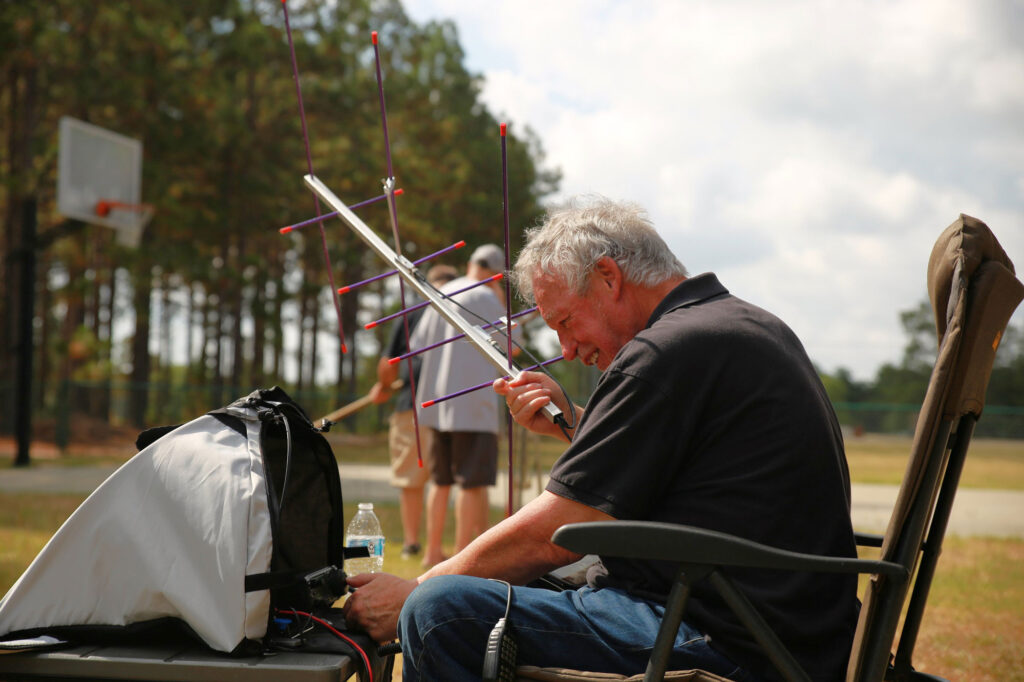 Mark Gibson, N4MQU, attempting to contact a passing satellite on amature radio.