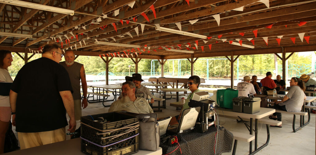 Amateur radio operators talking at club field day, 2024.