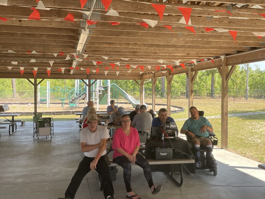 K4RNC club members, seated at picnic tables during 2025 ARRL field day.
