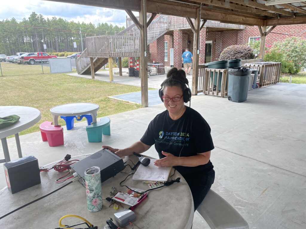 Olivia at her ham radio making contacts at ARRL Field Day.